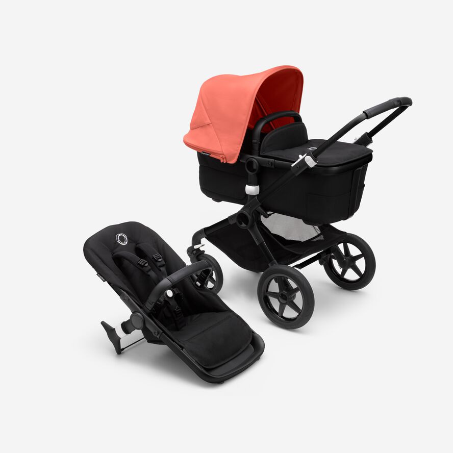 Bugaboo Fox 3 bassinet and seat stroller with black frame, black fabrics, and red sun canopy.