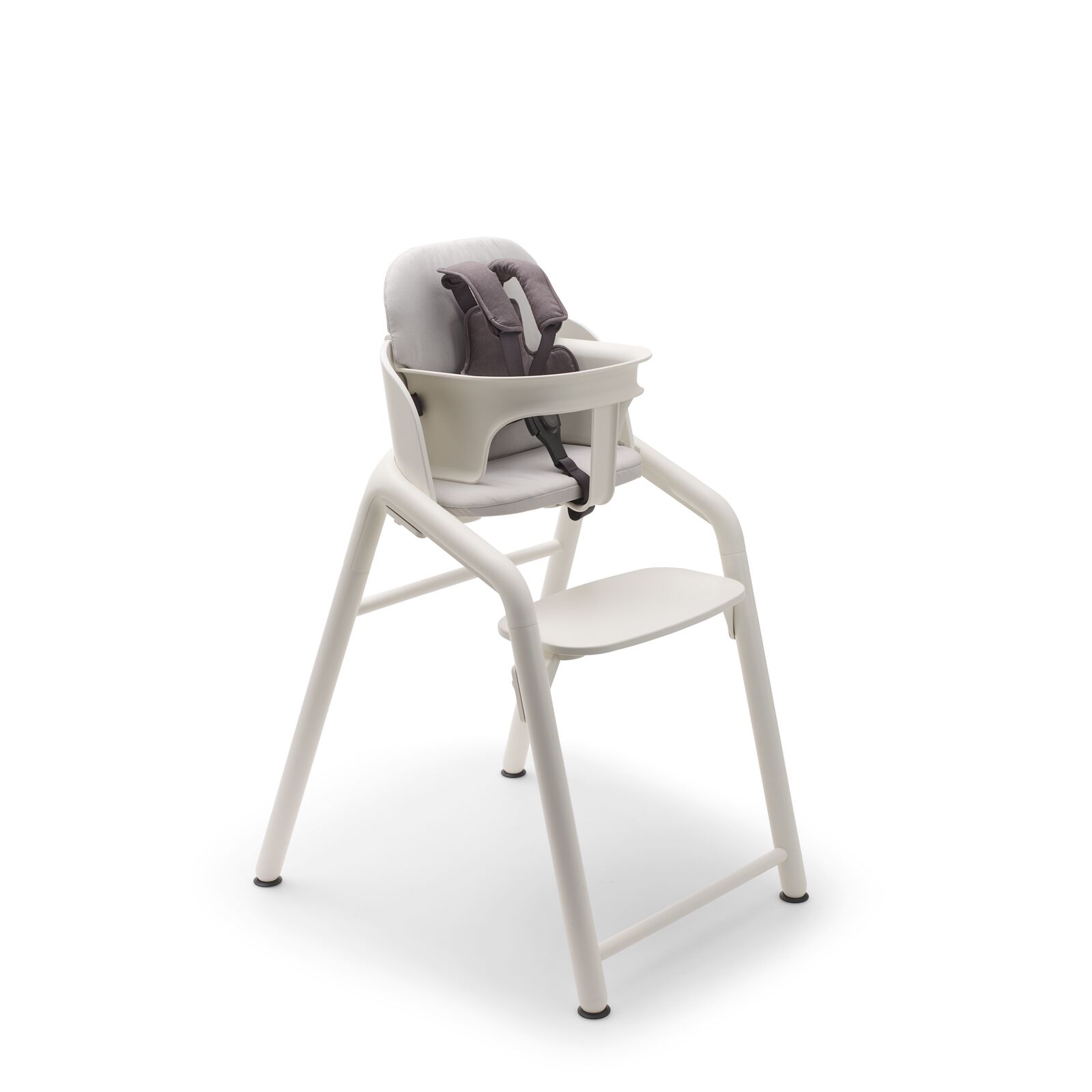 Bugaboo Giraffe chair, baby set with harness, and baby pillow set, all in white.