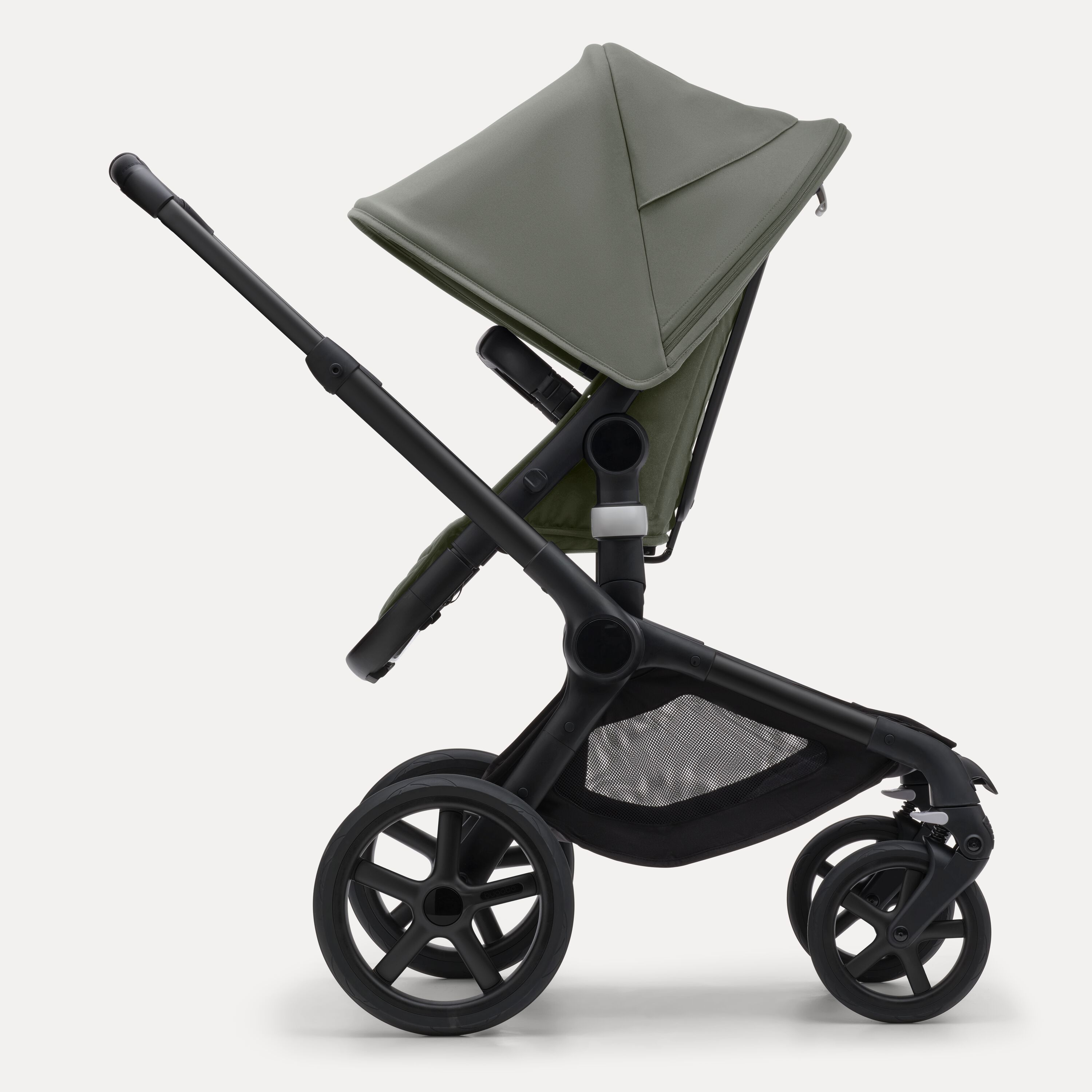 Side view of the Bugaboo Fox 5 seat pram with black chassis, forest green fabrics and forest green sun canopy. - Main Modal Image Slide 3 of 12