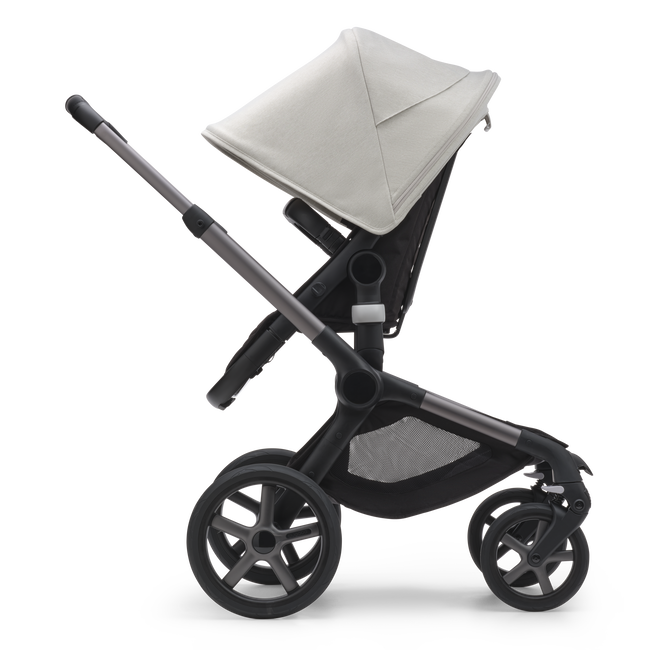 Side view of the Bugaboo Fox 5 seat stroller with graphite chassis, midnight black fabrics and misty white sun canopy.