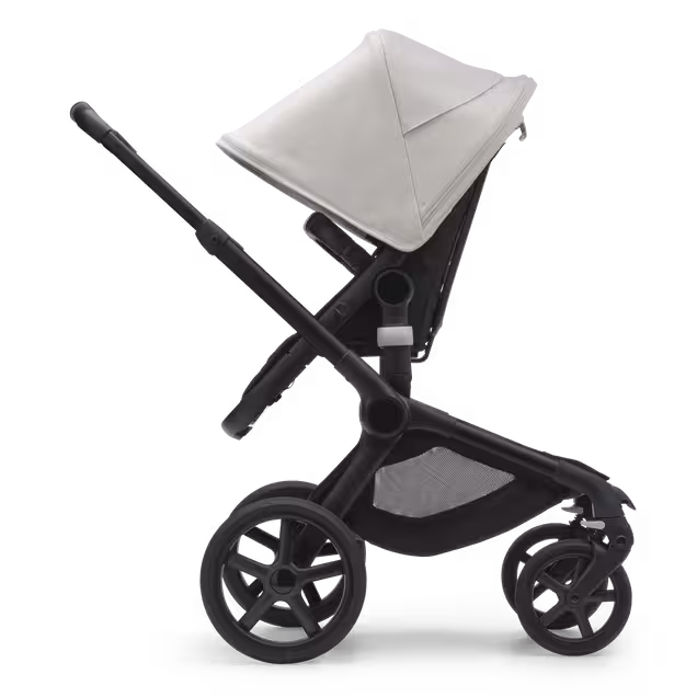 Side view of the Bugaboo Fox 5 seat stroller with black chassis, midnight black fabrics and misty white sun canopy. - Main Image Slide 3 of 12
