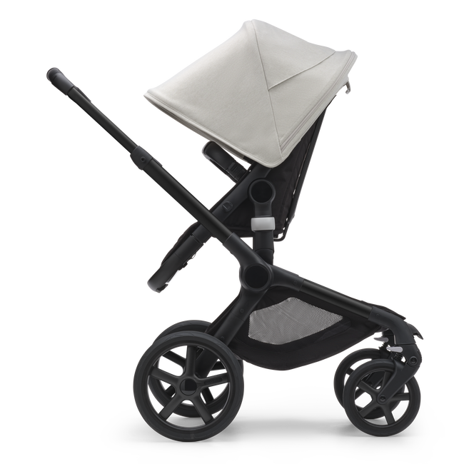 Side view of the Bugaboo Fox 5 seat stroller with black chassis, midnight black fabrics and misty white sun canopy.
