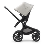 Side view of the Bugaboo Fox 5 seat stroller with black chassis, midnight black fabrics and misty white sun canopy.