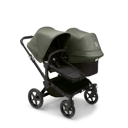 Bugaboo Donkey 5 Duo seat and bassinet stroller with black chassis, midnight black fabrics and forest green sun canopy.