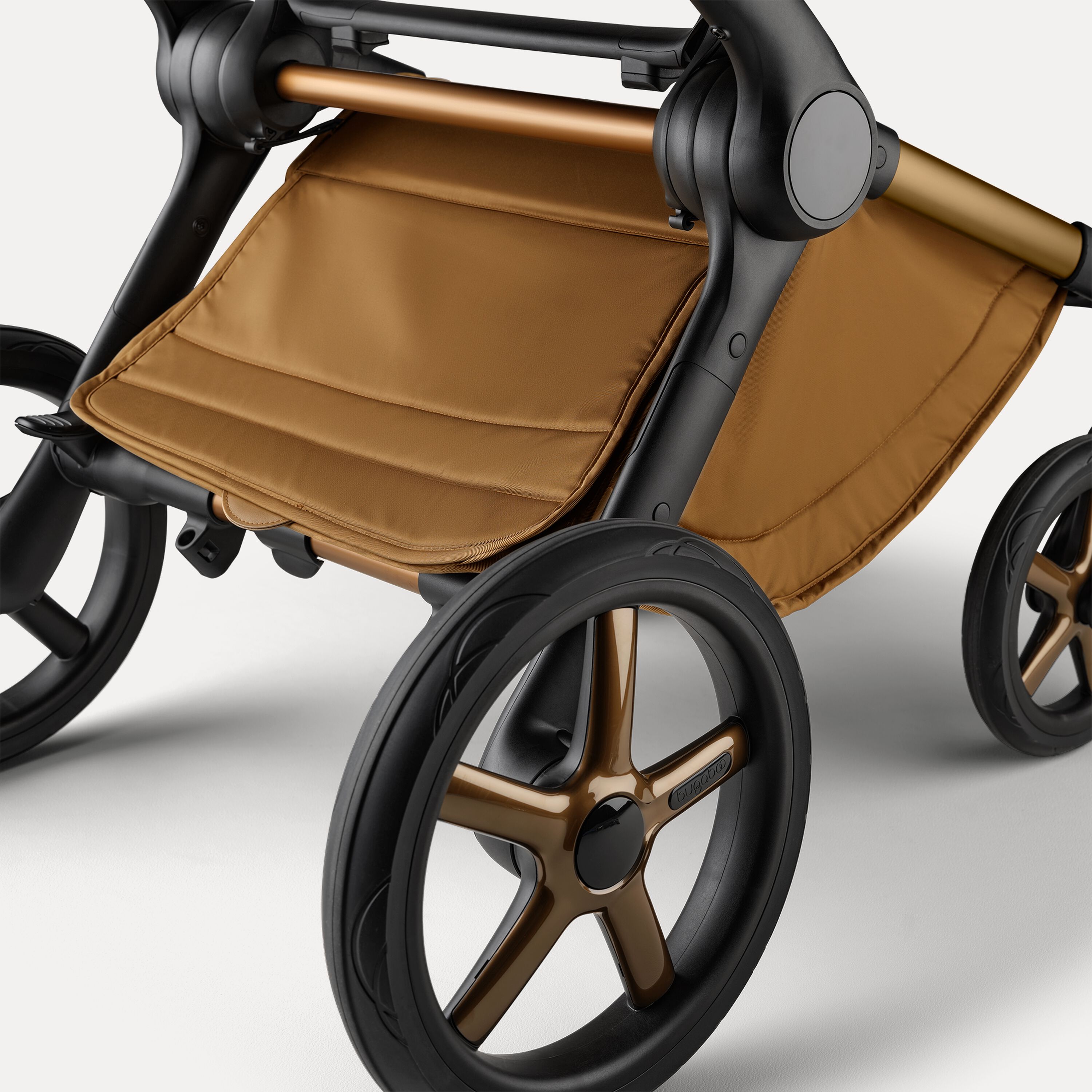 A close up of the underseat basket of the Bugaboo Fox 5 Noir Limited Edition pushchair in Amber Glow. - Main Modal Image Slide 6 of 15