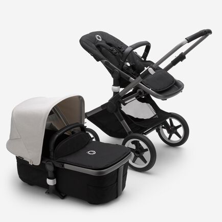 Bugaboo Fox 3 bassinet and seat stroller with graphite frame, black fabrics, and white sun canopy.
