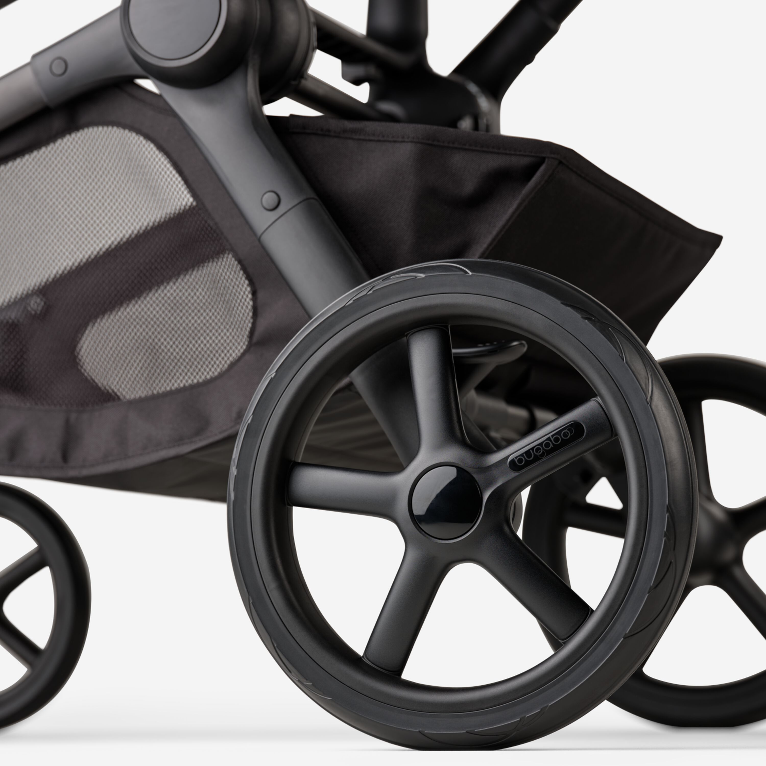 A close-up of the rear wheels and underseat basket of the Bugaboo Kangaroo 2-in-1 stroller. - Main Modal Image Slide 14 of 18