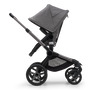 Side view of the Bugaboo Fox 5 seat stroller with graphite chassis, grey melange fabrics and grey melange sun canopy. - Thumbnail Slide 4 of 15