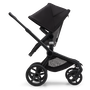 Side view of the Bugaboo Fox 5 seat pram with black chassis, forest green fabrics and forest green sun canopy. - Thumbnail Slide 4 of 13