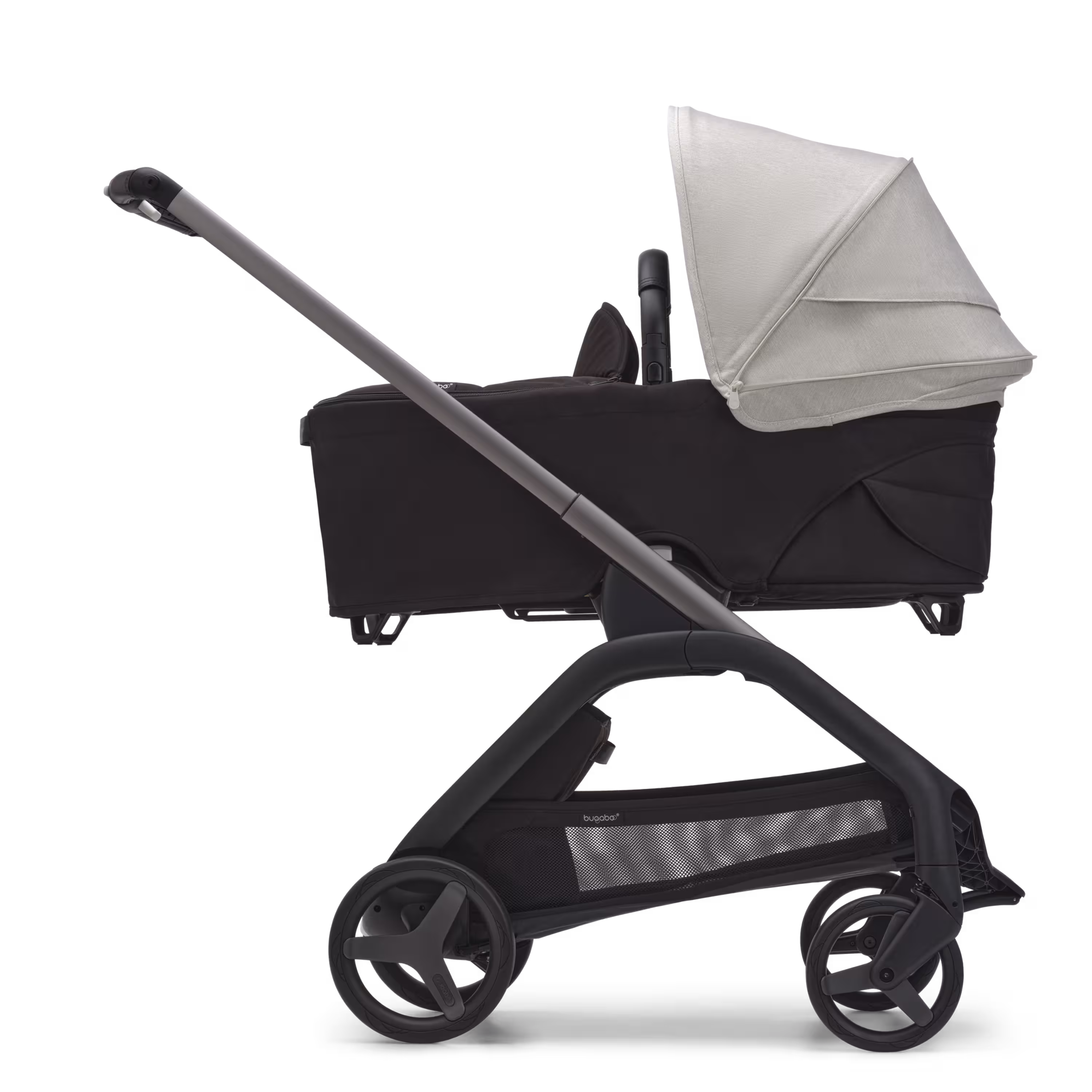 Side view of the Bugaboo Dragonfly bassinet stroller with graphite chassis, midnight black fabrics and misty white sun canopy. - Main Modal Image Slide 3 of 16