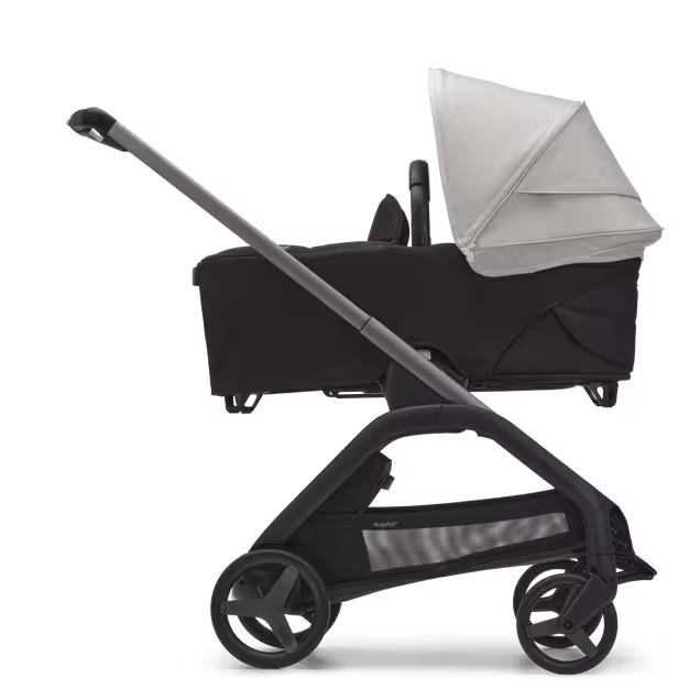 Side view of the Bugaboo Dragonfly bassinet stroller with graphite chassis, midnight black fabrics and misty white sun canopy. - Main Image Slide 3 of 16