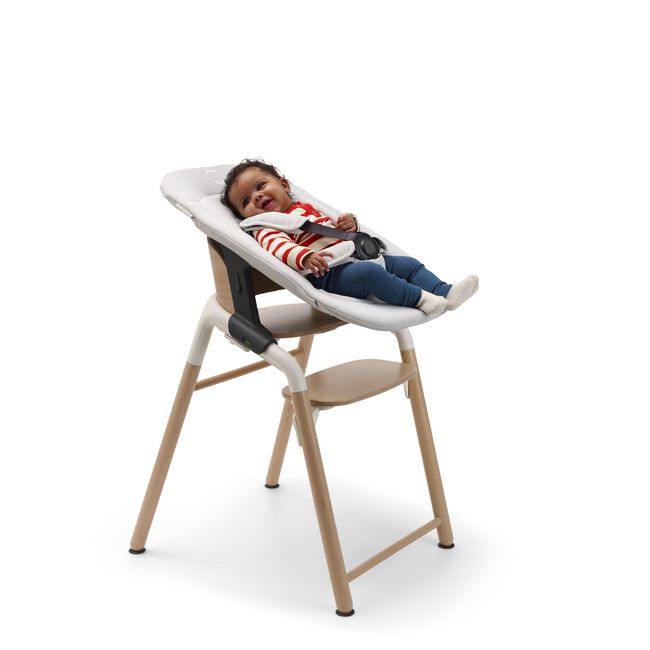 Baby in a Bugaboo Giraffe chair with newborn set. - Main Image Slide 4 van 7