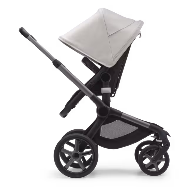 Side view of the Bugaboo Fox 5 carrycot pushchair with graphite chassis, midnight black fabrics and misty white sun canopy. - Main Image Slide 3 of 13