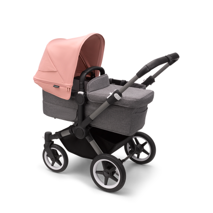 Bugaboo Donkey 5 Mono bassinet stroller with graphite chassis, grey melange fabrics and morning pink sun canopy.
