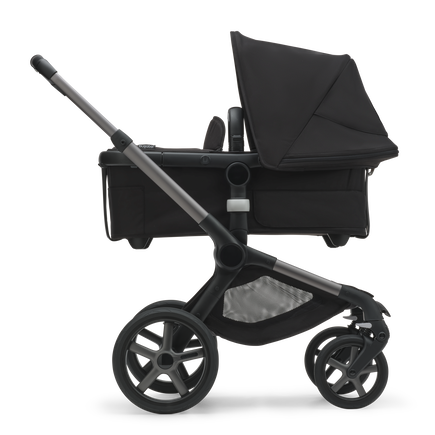 Side view of the Bugaboo Fox 5 bassinet stroller with graphite chassis, midnight black fabrics and midnight black sun canopy. - view 2