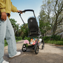 View of a Bugaboo Dragonfly pushchair from behind, with a fully-loaded underseat basket containing toys and groceries. - Thumbnail Slide 8 of 18