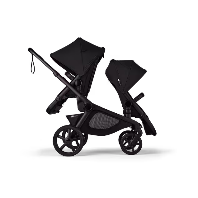 Side view of Bugaboo Kangaroo 2-in-1 tandem stroller with two seats, one facing parent and the other facing the world, with Midnight Black fabrics and Midnight Black sun canopies. - Main Image Slide 4 of 18