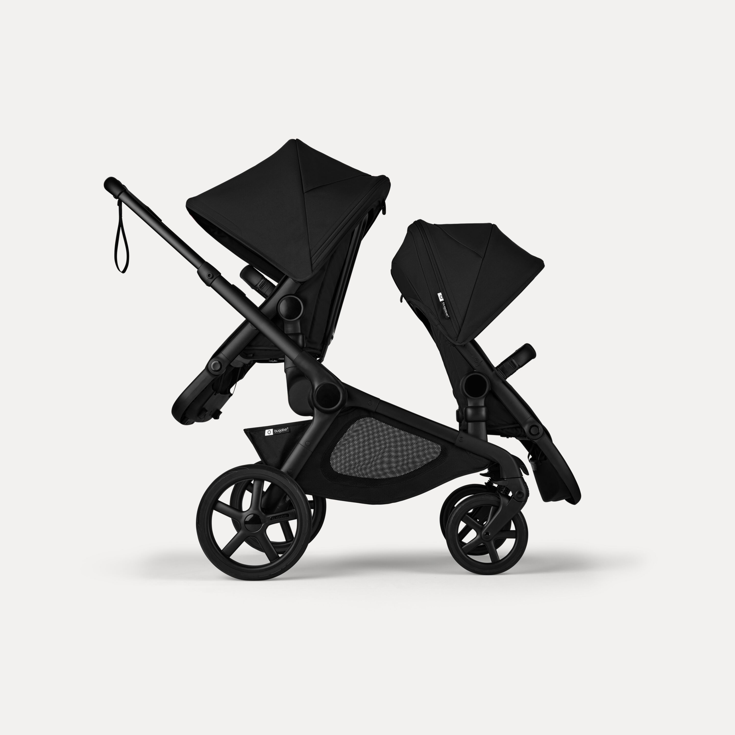 Side view of Bugaboo Kangaroo 2-in-1 tandem stroller with two seats, one facing parent and the other facing the world, with Midnight Black fabrics and Midnight Black sun canopies. - Main Modal Image Slide 4 of 18