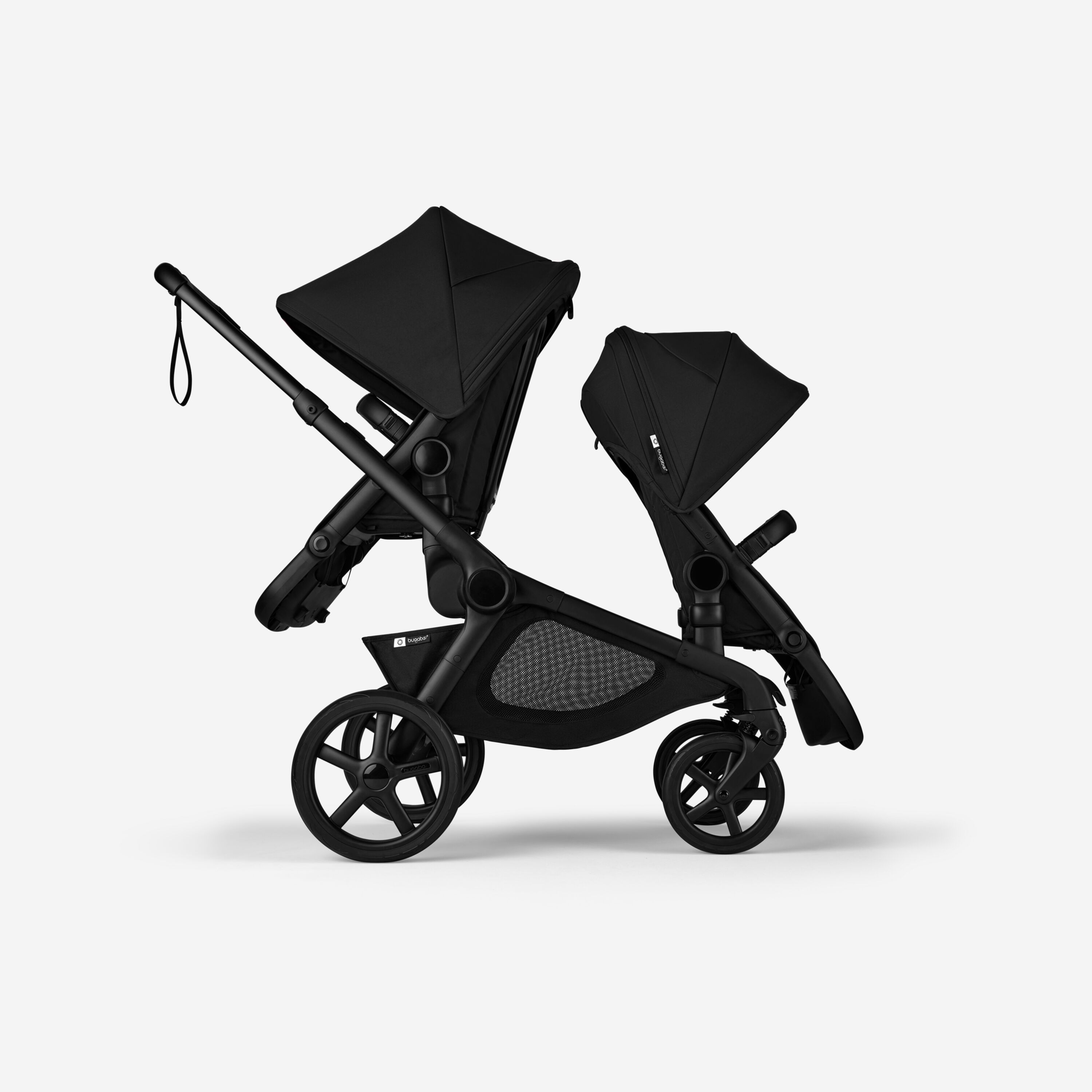 Side view of Bugaboo Kangaroo 2-in-1 tandem stroller with two seats, one facing parent and the other facing the world, with Midnight Black fabrics and Midnight Black sun canopies. - Main Modal Image Slide 4 of 18