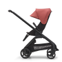 Side view of the Bugaboo Dragonfly seat stroller with black chassis, midnight black fabrics and sunrise red sun canopy.