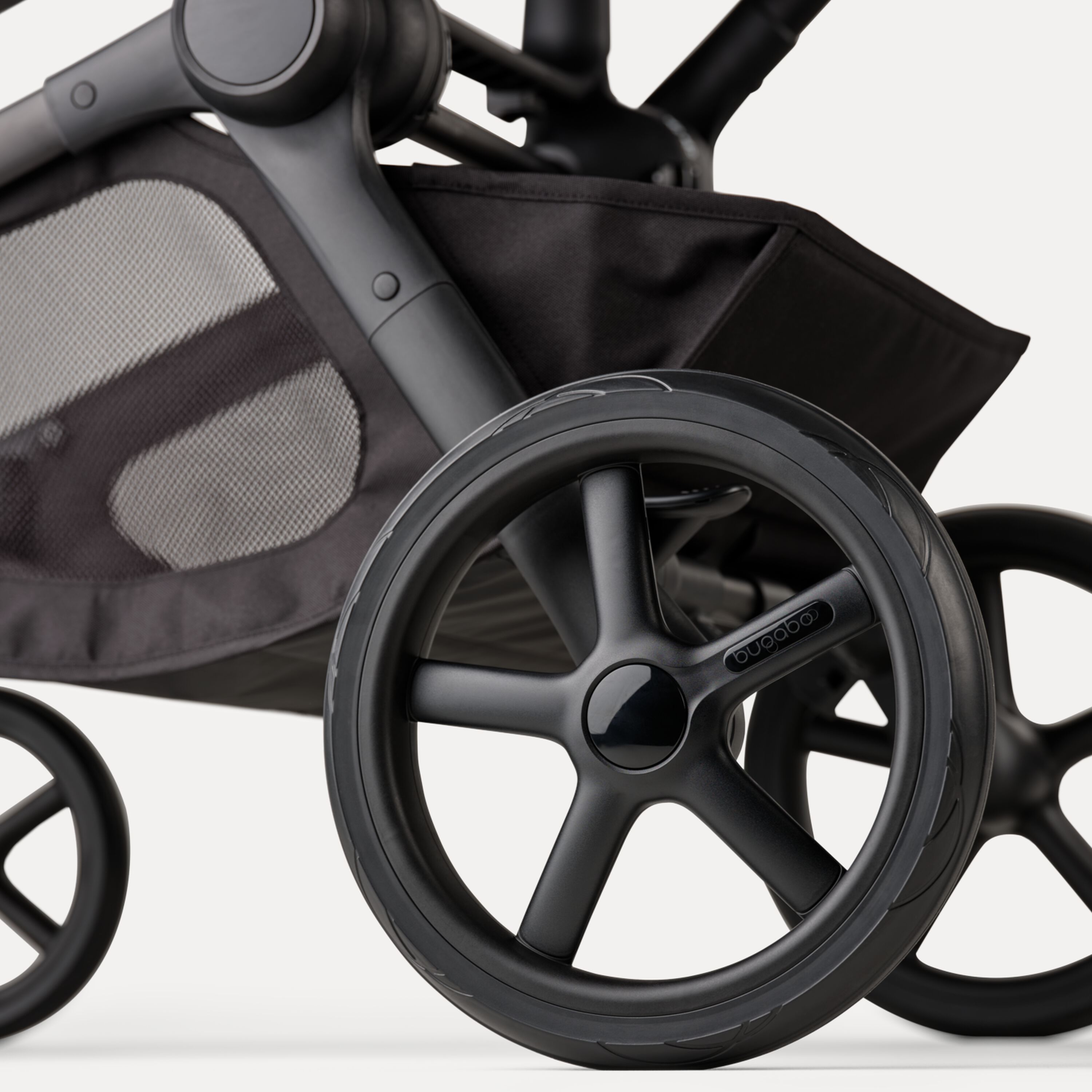 A close-up of the rear wheels and underseat basket of the Bugaboo Kangaroo 2-in-1 stroller. - Main Modal Image Slide 15 of 20