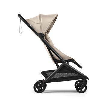 Side view of a Bugaboo Butterfly 2 ultra-compact travel pram with black chassis, Desert Taupe fabrics, and Desert Taupe sun canopy. - view 2
