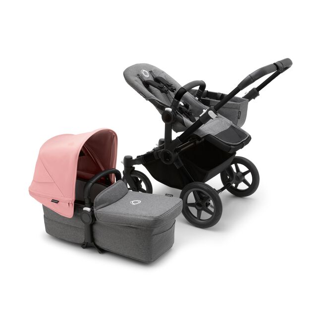 Bugaboo Donkey 5 Mono seat stroller with black chassis and grey melange fabrics, plus bassinet with morning pink sun canopy.