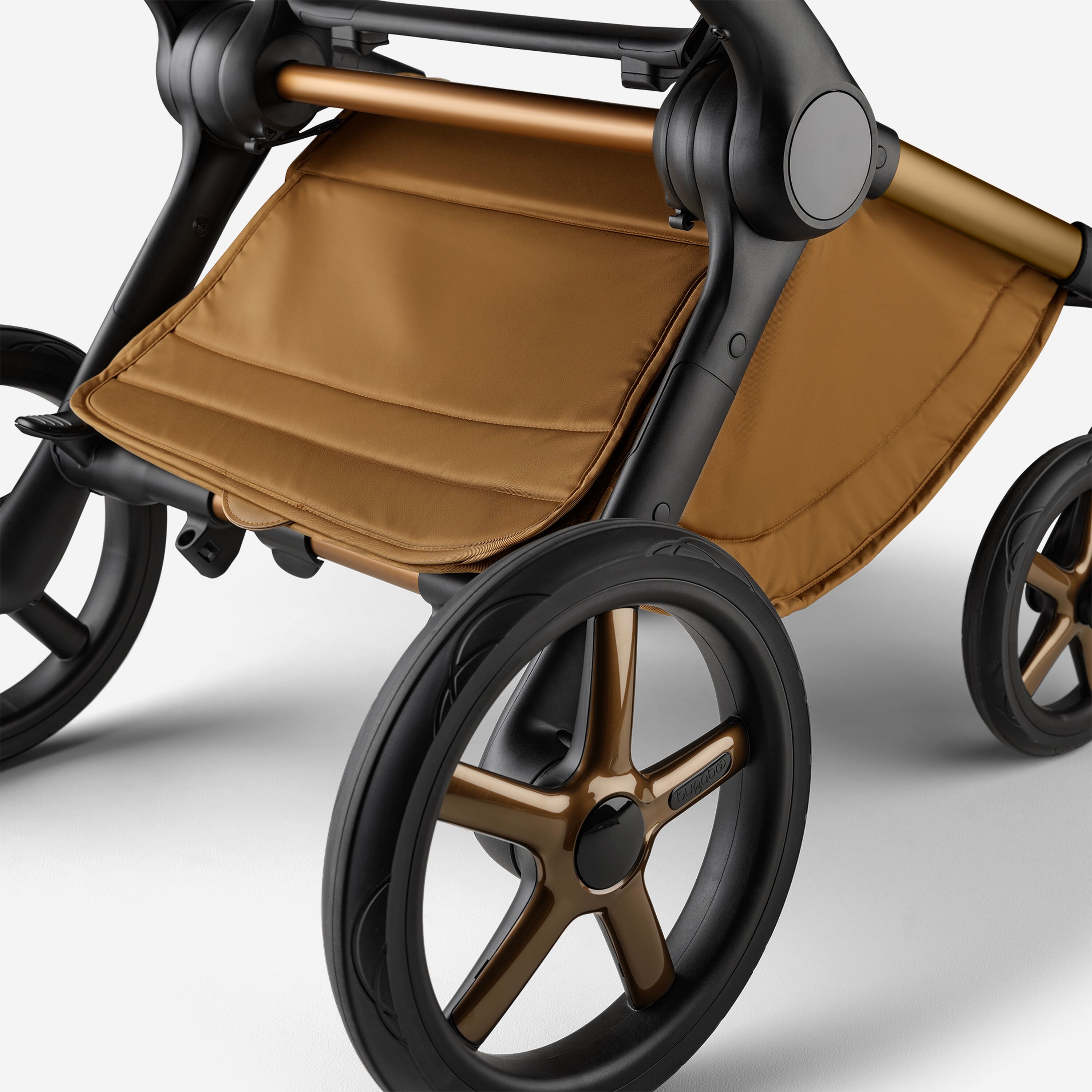 A close up of the underseat basket of the Bugaboo Fox 5 Noir Limited Edition stroller in Amber Glow. - Main Modal Image Slide 6 of 15