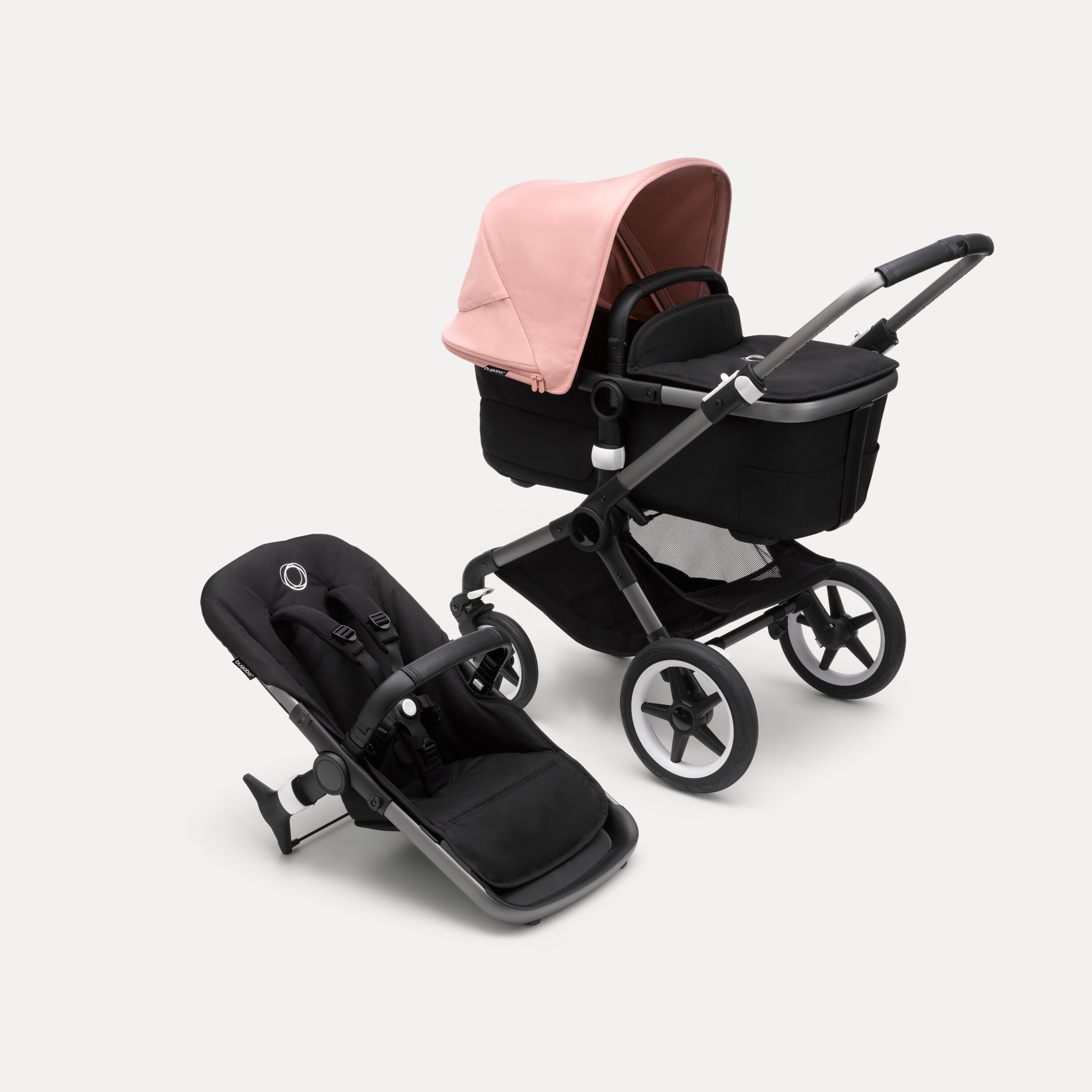 Bugaboo Fox 3 bassinet and seat stroller with graphite frame, black fabrics, and pink sun canopy. - Main Modal Image Slide 1 of 7