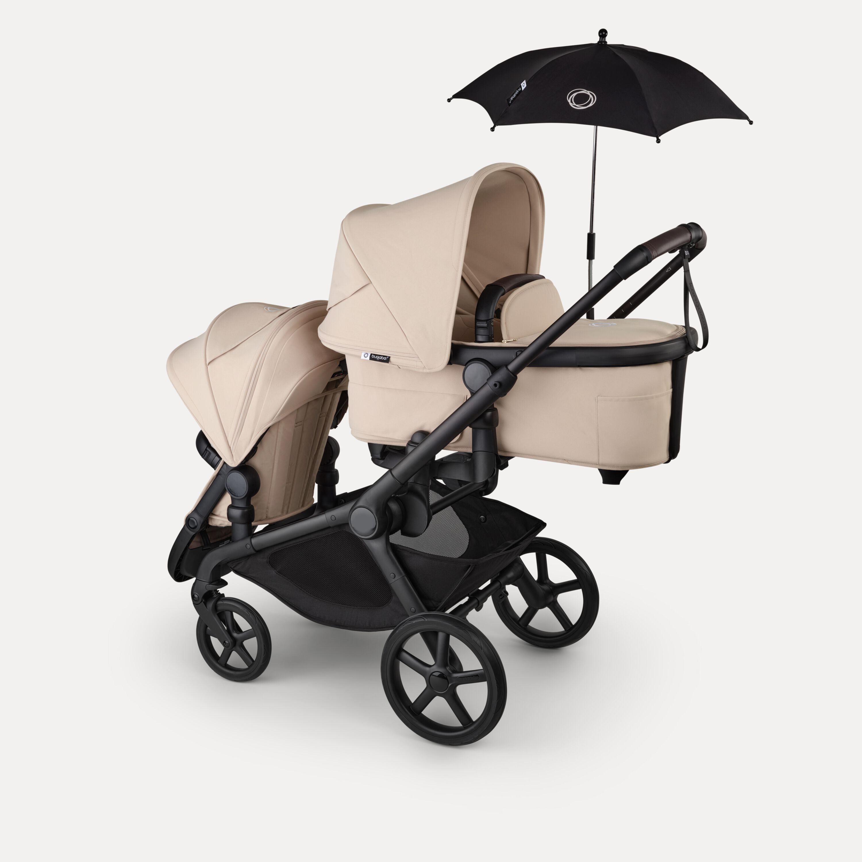 Bugaboo Kangaroo 2-in-1 tandem stroller with one bassinet above and one seat below, in Desert Taupe fabrics. A Bugaboo parasol is attached. - Main Modal Image Slide 17 of 18