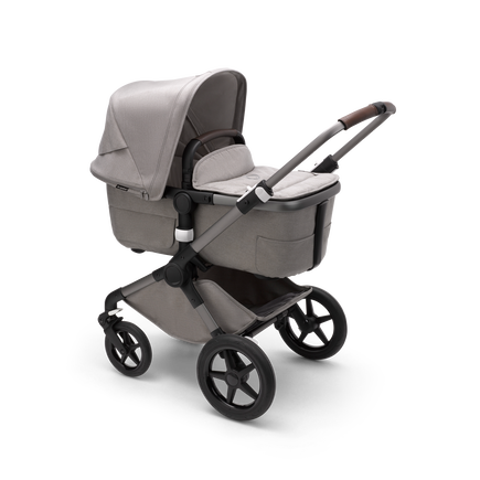 Bugaboo Fox 3 bassinet stroller with graphite frame, light grey fabrics and light grey sun canopy.
