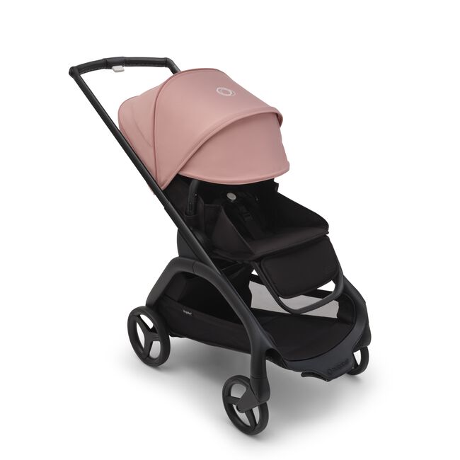 Bugaboo Dragonfly seat stroller with black chassis, midnight black fabrics and morning pink sun canopy. The sun canopy is fully extended.