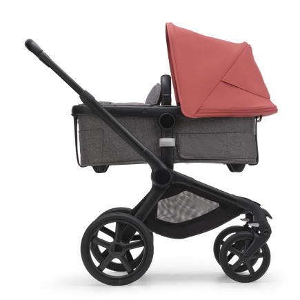 Side view of the Bugaboo Fox 5 bassinet stroller with black chassis, grey melange fabrics and sunrise red sun canopy. - view 2