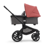 Side view of the Bugaboo Fox 5 bassinet stroller with black chassis, grey melange fabrics and sunrise red sun canopy.