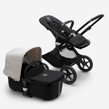 Bugaboo Fox 3 bassinet and seat stroller with black frame, black fabrics, and white sun canopy.