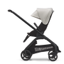 Side view of the Bugaboo Dragonfly seat stroller with black chassis, midnight black fabrics and misty white sun canopy.