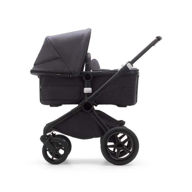 Side view of a Fox 3 bassinet stroller with black frame and mineral washed black fabrics.