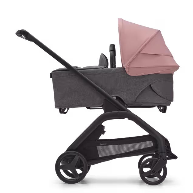 Side view of the Bugaboo Dragonfly bassinet stroller with black chassis, grey melange fabrics and morning pink sun canopy. - Main Image Slide 3 of 15