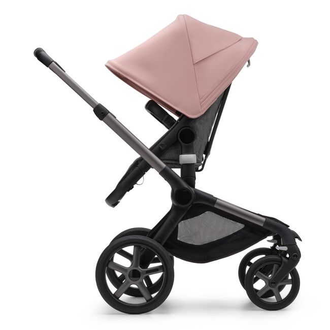Side view of the Bugaboo Fox 5 seat stroller with graphite chassis, grey melange fabrics and morning pink sun canopy. - Main Image Slide 4 of 15