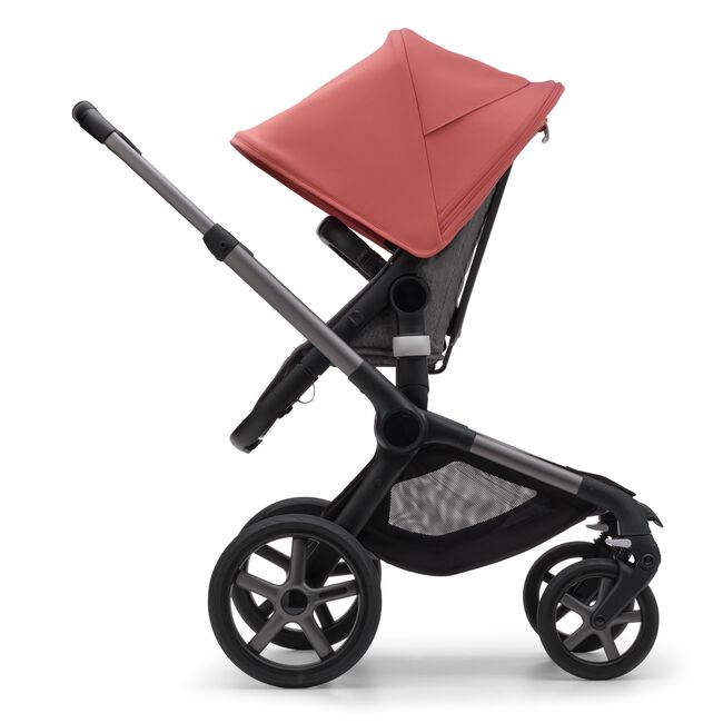 Side view of the Bugaboo Fox 5 seat stroller with graphite chassis, grey melange fabrics and sunrise red sun canopy. - Main Image Slide 4 of 16