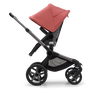 Side view of the Bugaboo Fox 5 seat stroller with graphite chassis, grey melange fabrics and sunrise red sun canopy. - Thumbnail Slide 4 of 16