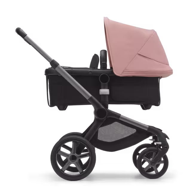 Side view of the Bugaboo Fox 5 carrycot pushchair with graphite chassis, midnight black fabrics and morning pink sun canopy. - Main Image Slide 2 of 13