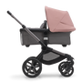 Side view of the Bugaboo Fox 5 bassinet stroller with graphite chassis, grey melange fabrics and morning pink sun canopy. - Thumbnail Modal Image Slide 3 of 15