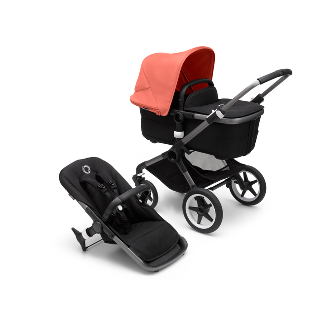 Bugaboo Fox 3 bassinet and seat stroller with graphite frame, black fabrics, and red sun canopy.