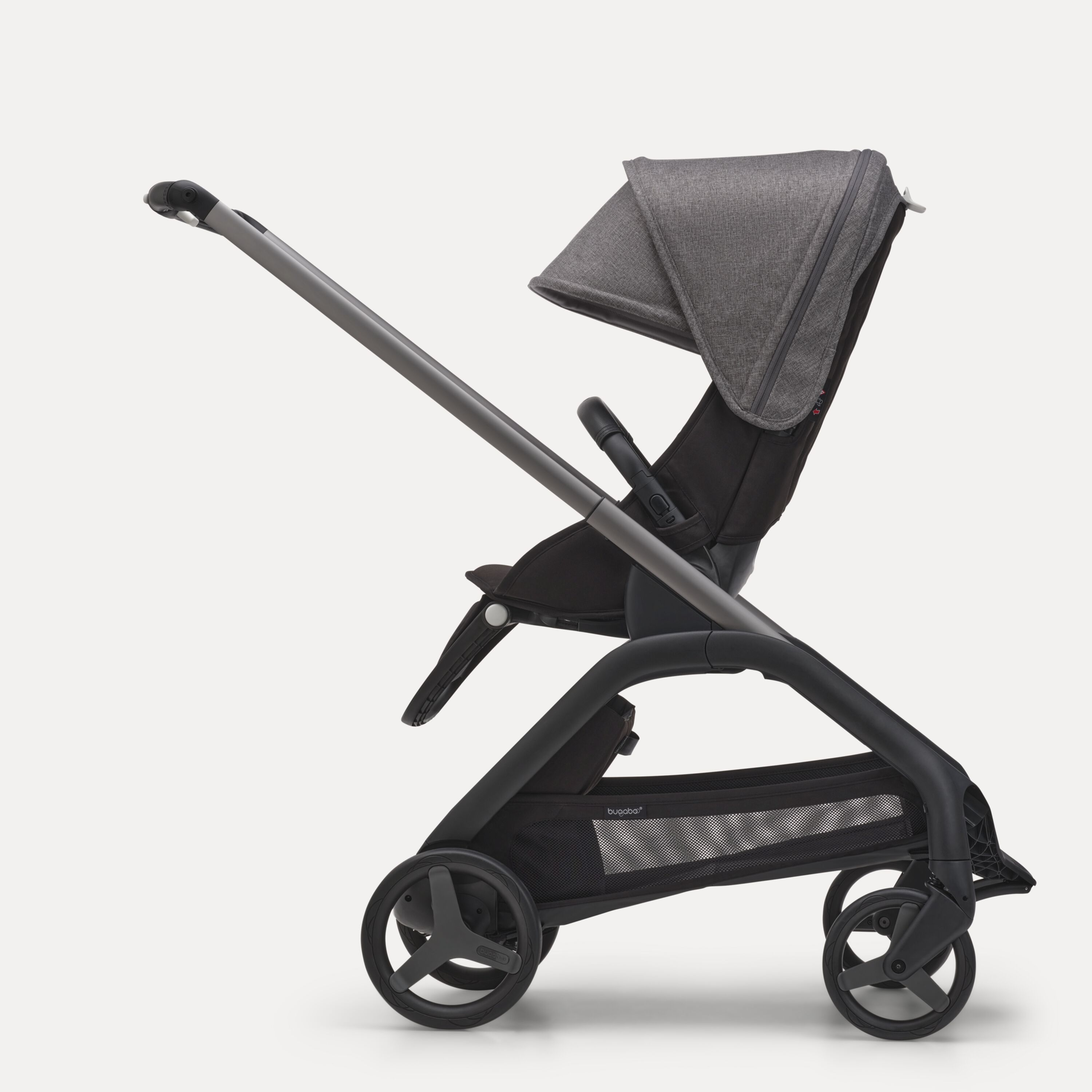 Side view of the Bugaboo Dragonfly seat stroller with graphite chassis, midnight black fabrics and grey melange sun canopy. - Main Modal Image Slide 2 of 16