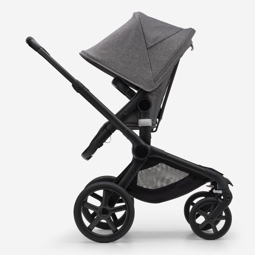 Side view of the Bugaboo Fox 5 seat stroller with black chassis, grey melange fabrics and grey melange sun canopy.