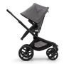 Side view of the Bugaboo Fox 5 seat stroller with black chassis, grey melange fabrics and grey melange sun canopy. - Thumbnail Slide 4 of 15