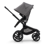 Side view of the Bugaboo Fox 5 seat stroller with black chassis, grey melange fabrics and grey melange sun canopy.