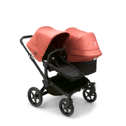 Bugaboo Donkey 5 Duo seat and bassinet stroller with black chassis, midnight black fabrics and sunrise red sun canopy.