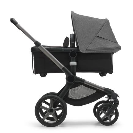 Side view of the Bugaboo Fox 5 bassinet stroller with graphite chassis, midnight black fabrics and grey melange sun canopy. - view 2